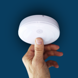 Fire Safety Assessor testing a smoke alarm in owners building for AFSS