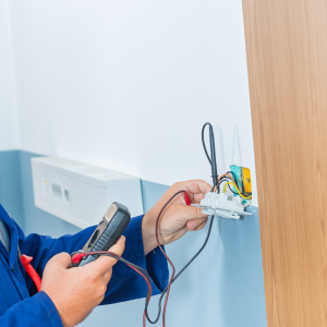 Test and Tag Services across Australia and New Zealand. Man testing electrical equipment in commercial building.