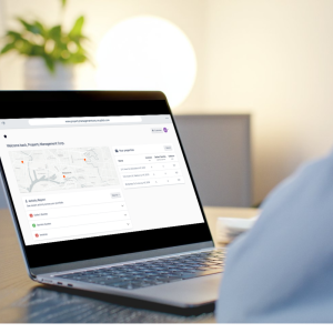 Facility manager hold a laptop showcasing all fire reports, AFSS documents and fire compliance works to ensure compliance of his multi-site retail franchise.
